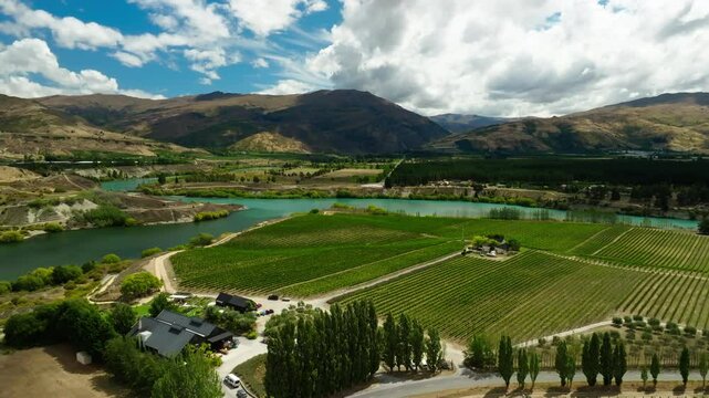 Aerial Natural Pattern Of Agricultural Field On Cliff, Drone Flying Forward During Sunny Day - Bannockburn, New Zealand