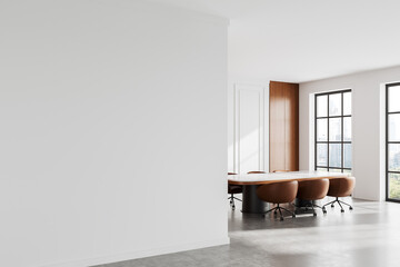 Minimalist office interior with empty white wall and large table with chairs near windows overlooking cityscape. 3D Rendering