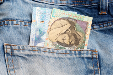 Kazakhstani tenge in the pocket of blue jeans