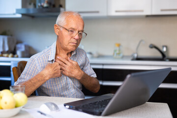 Fototapeta premium Elderly man describing symptoms to doctor during online consultation