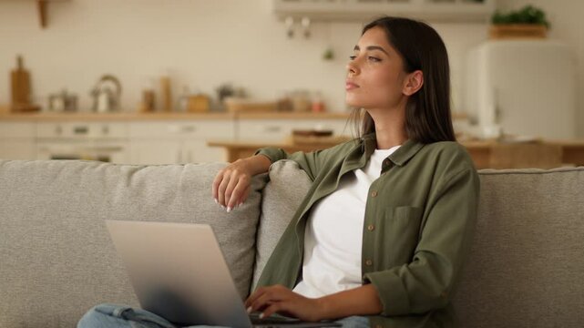 Pensive thinking Indian woman Arabian female ethnic girl user freelancer student businesswoman online business using computer typing laptop at home shopping internet booking food delivery order app