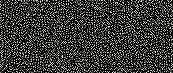 Seamless small dense polkadot  spots pattern in white on black background. Abstract dot cellular texture.