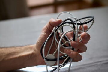 Tangled Cords in Hand The Everyday Clutter and Chaos of Our Modern Technology Life