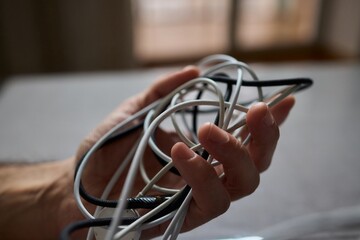 Tangled Cords in Hand The Everyday Clutter and Chaos of Our Modern Technology Life
