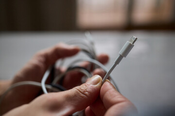 Tangled Cords in Hand The Everyday Clutter and Chaos of Our Modern Technology Life