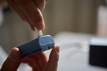 A closeup view showcasing hands actively connecting a portable device for charging purposes