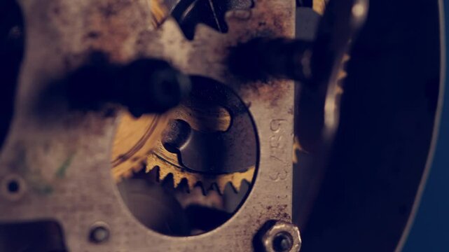 Close-up of intricate vintage clock mechanism demonstrating gears and craftsmanship in a workshop setting