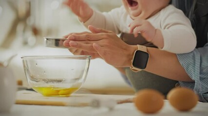 A parent guides their baby in measuring eggs while baking. The kitchen is bright and organized, filled with cooking tools and fresh ingredients. The baby shows excitement during the process