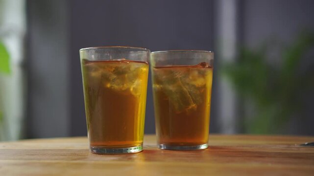 Two glasses of Ocha tea are served on the restaurant table and ready to drink.