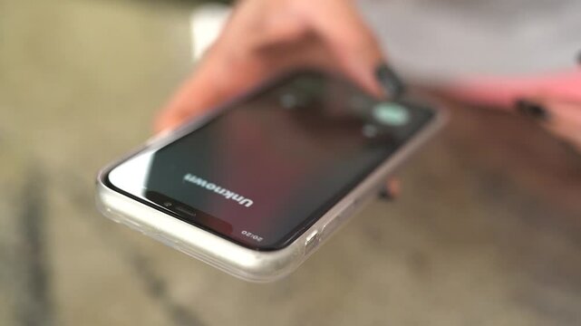Unknown call from scammers on a mobile phone. Vertical video.