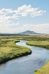 Serene river meanders through lush green meadows under a bright, blue sky. Distant mountains add depth to this picturesque landscape.