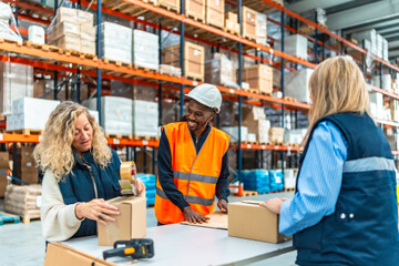Warehouse workers talking while preparing packages to deliver