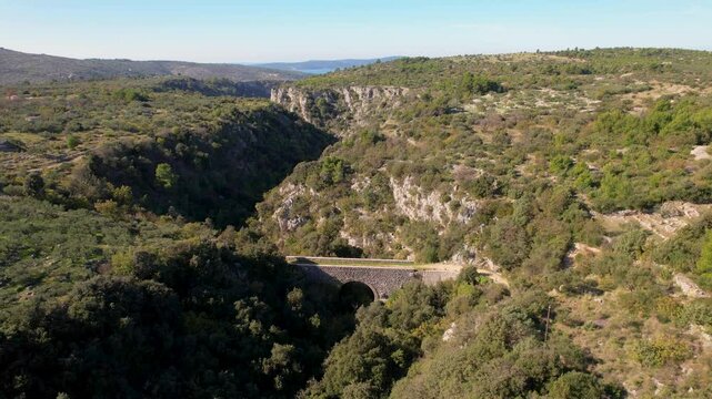 Aerial flight over a local Franz Joseph bridge on the island of Brac, Croatia near the towns of Sutivan, Milan and Supetar. Traditional Austrian architecture on Dalmatian coast.