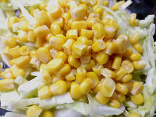 Close up of sweet corn salad with green lettuce and sweet corn.