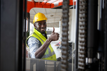 African American warehouse worker driving forklift car and show thumbs up in distribution storehouse