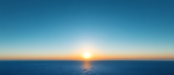 Obraz premium Ocean sunset with calm waters and clear sky.