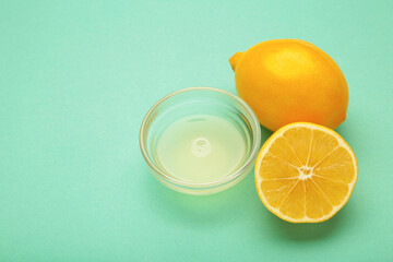Lemons juice on mint background. Space for text