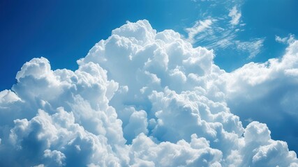 Fluffy white clouds in bright blue sky create serene and peaceful atmosphere  Ideal for nature and weather related concepts
