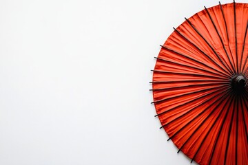 Vibrant Red Umbrella Against Minimalist White Background Perfect for Conceptual Photography and Artistic Presentations