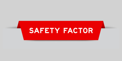 Red color inserted label with word safety factor on gray background