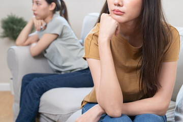 lgbt couple have a quarrel sitting separated on the sofa