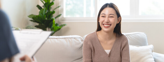 Young woman in a mental therapy session talking with a psychologist in the office.