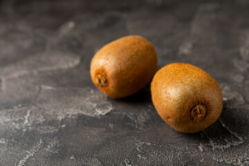 Kiwi on wooden background. Whole fruit and slices pieces of green kiwi on table. fresh ripe juicy...