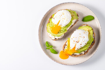 Two avocado open sandwiches with egg. Keto and diet concept. Healthy toast food for breakfast.