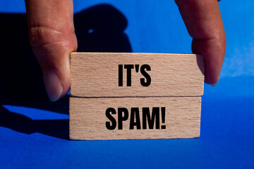It's spam message written on wooden blocks with blue background. Conceptual it's spam symbol. Copy...