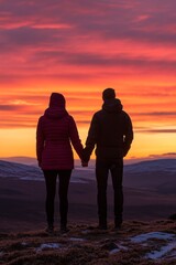 Silhouetted Couple Holding Hands Against a Vivid Mountain Sunset, Romantic Getaway in Nature