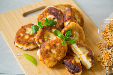 cooked fried pea pies on a wooden board