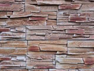 Decorative texture of red marble stone cobblestones for the wall.