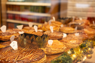 Festive pastries displayed in a bakery window during the holiday season