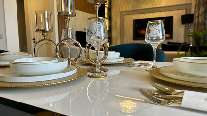 Elegant dining table setting with gold accents, crystal glassware, and luxurious decor, ideal for fine dining, interior design showcases, hospitality promotions, or lifestyle marketing.
