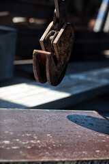 Clamp for lifting sheet metal with a crane. Clamp for moving metal plates with thick metal plates lying next to them