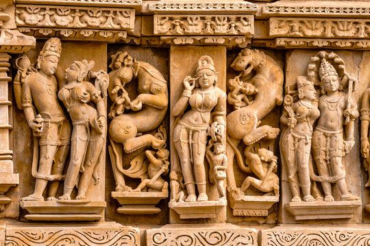 India. Madhya Pradesh state. The Khajuraho Group of Monuments are a group of Hindu and Jain temples. Parshvanatha Jain Temple. Bas relief of a woman putting kohl on her eyes