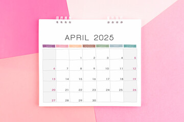 April month desk calendar for 2025 year on colorful background.