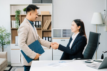 Fototapeta premium Two confident business man shaking hands during a meeting in the office