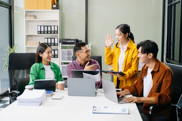 Happy businesspeople while collaborating on a new project in an office. Group of diverse businesspeople