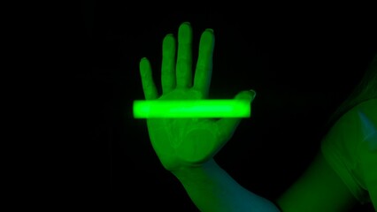 Woman touches glass screen panel, open palm print on transparent surface, green light scanner scanning the hand print. Template for digitalization concept.