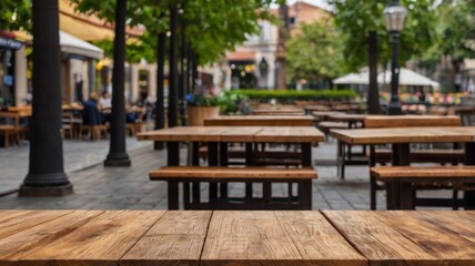 Obraz premium Empty wood table top on outdoor aesthetic cafe with a blurred background. The focus is on the table surface.