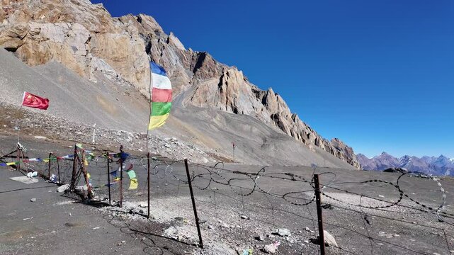 Manaslu Circuit, Nepal: Point of view of a trekker walking along the fence Nepal - Tibet border, the Rui La pass, near Samdo in the Himalaya in Nepal. 