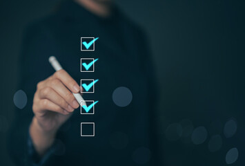 Business performance checklist concept Young business woman using laptop surveys online checklist...