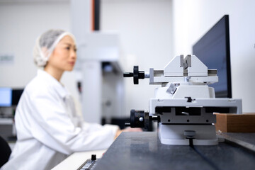 Japanese expert engineer working in factory research and development center.