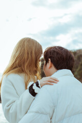 Young couple in love outdoors.
Close up of a couple hugging on the seashore, from behind