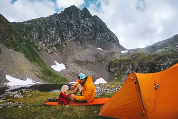 Fotobehang Family camping in mountains - father and kid traveling with tent gear travel vacations dad and daughter hiking together active adventure outdoor healthy lifestyle parent and child playing on mat © EVERST