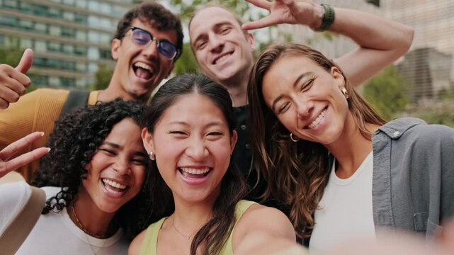 Diverse group of interracial students smiling and looking at camera, focus on girls