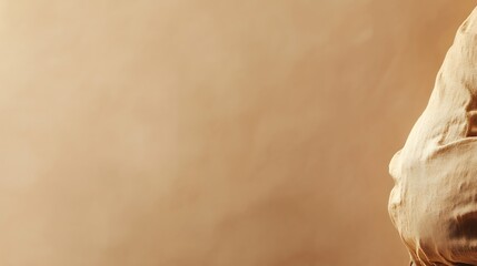 Beige Fabric Draped Against A Neutral Background