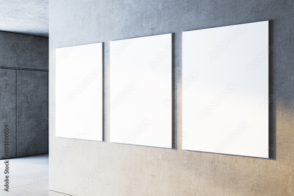 Aufkleber three blank white canvases on a gray concrete wall in a contemporary gallery setting. 3d rendering