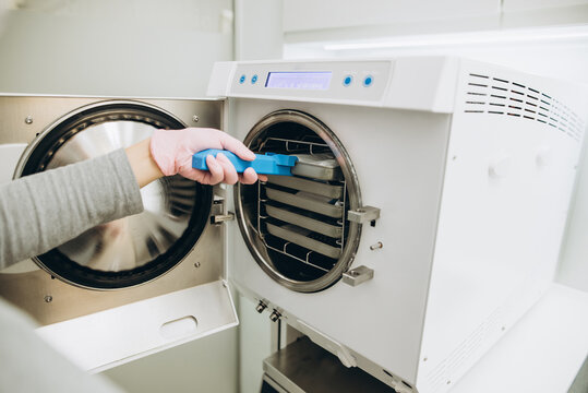 Hand operating a freeze dryer in a laboratory for food preservation